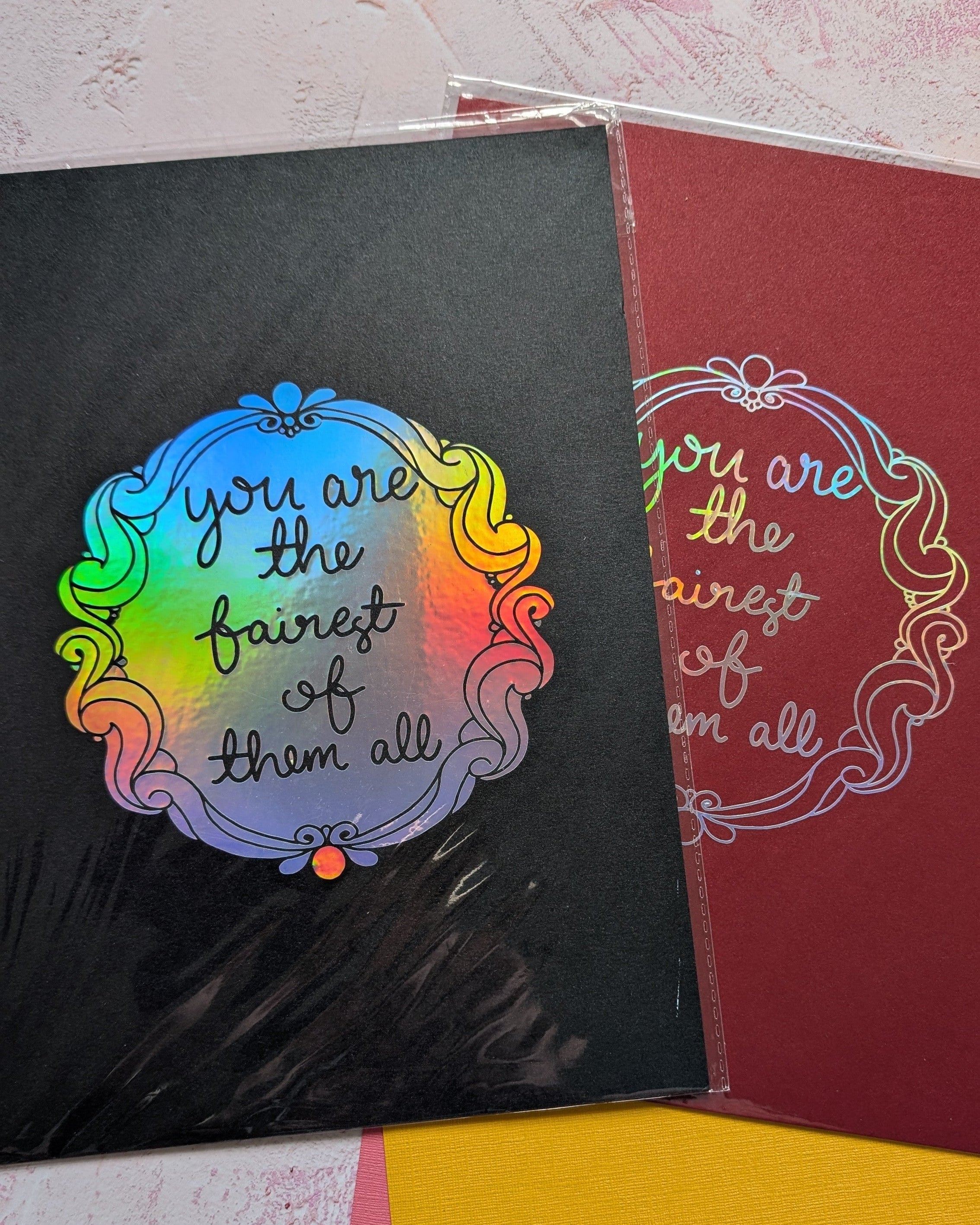 Two Prints on Black and Red Card, with mirror design in holographic vinyl reading 'you are the fairest of the all)