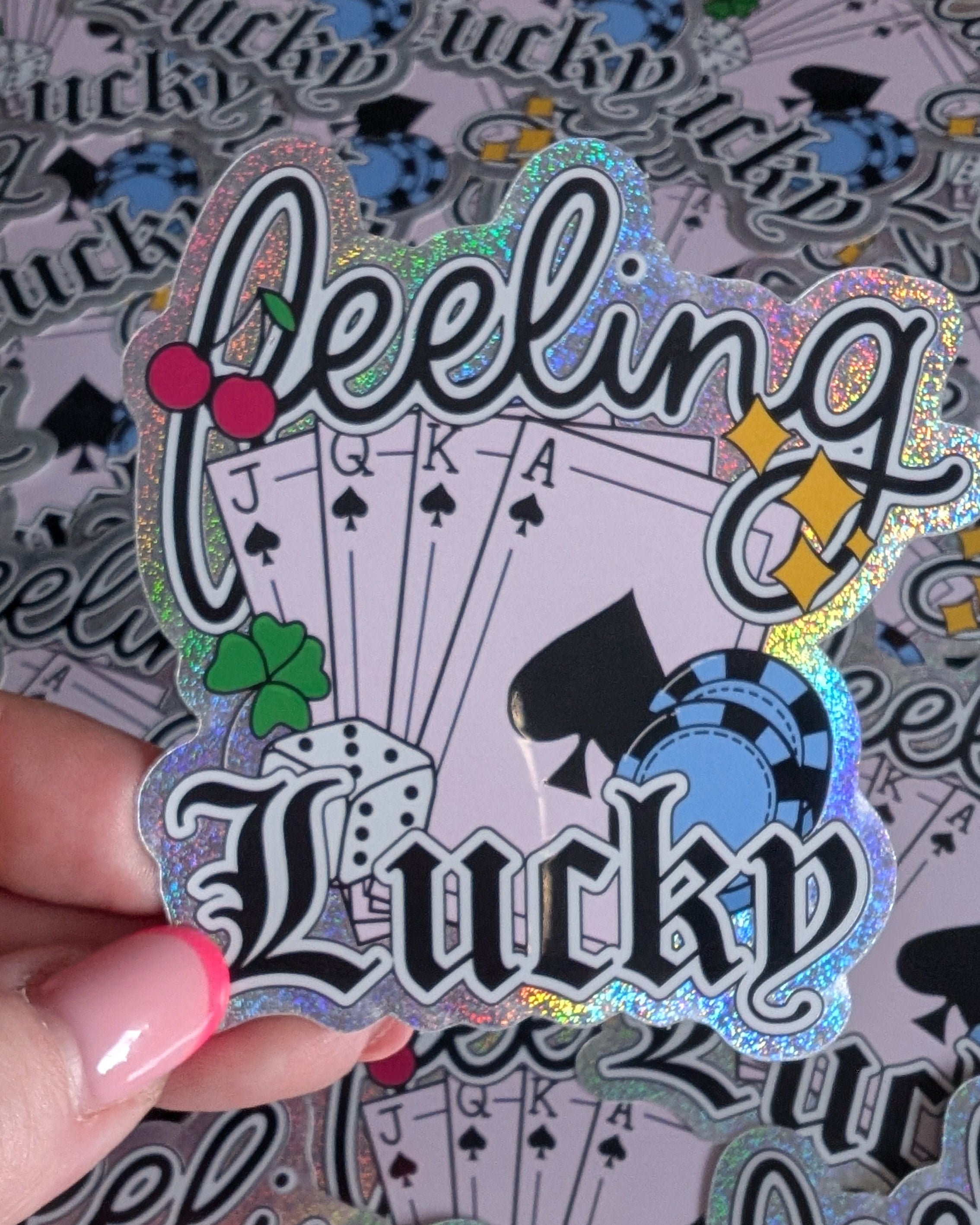 Sticker with 'Feeling Lucky' text held over playing card background
